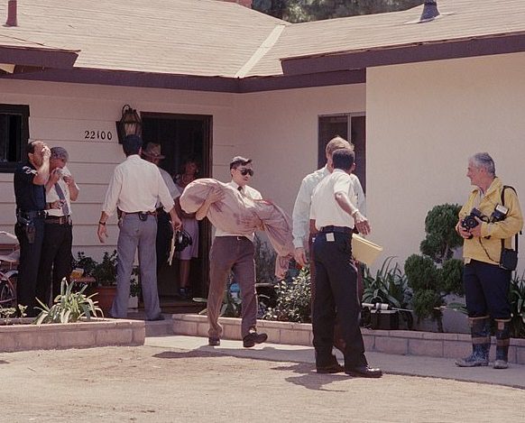 LA County Deputy Coroner David Masuda carrying Judith's body from the home on July 27, 1988